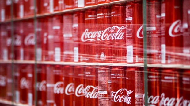 Cans of Coke soda sit in a storage area prior to shipping at the Coca-Cola Hellenic Bottling Co. SA plant in Brovary, Ukraine, on Wednesday, May 10, 2017. Heineken NV, Coca-Cola HBC AG and Castel Group are among companies bidding for a majority stake in Coca-Cola Beverages Africa, according to people familiar with the matter. 