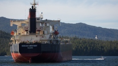 The Ocean Destiny bulk carrier freight ship navigates near the Port of Prince Rupert in Prince Rupert, British Columbia, Canada, on Tuesday, Aug. 23, 2016. Facing five major energy initiatives in B.C., Canadian Prime Minister Trudeau will choose which constituency to abandon. He's allowed a hydroelectric dam to proceed; pending are decisions on Enbridge Inc.'s Northern Gateway crude pipeline, Petroliam Nasional Bhd.'s LNG project on Lelu Island, a pipeline expansion by Kinder Morgan Inc., as well as a ban on crude oil tankers. 
