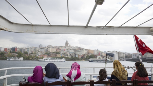 Female passengers look towards the city from the deck of a ferry boat on the Bosporus Strait in Istanbul, Turkey, on Wednesday, July 20, 2016.