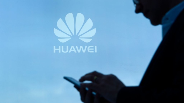 A visitor uses his mobile phone at the Huawei stand on the second day of the Mobile World Congress on February 28, 2017 in Barcelona. 