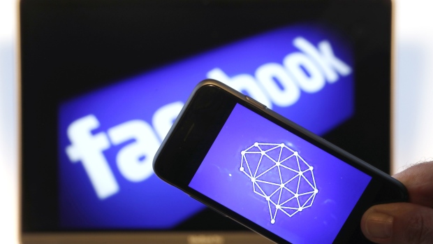 A Cambridge Analytica symbol is displayed on an Apple Inc. iPhone against a backdrop of the Facebook Inc. sign shown on a computer screen in this arranged photograph in London, U.K., on Thursday, March 22, 2018. Facebook Inc.’s co-founder and chief executive officer Mark Zuckerberg has been called to appear before a House panel as fallout continues from revelations that Cambridge Analytica had siphoned data from some 50 million Facebook users as it built a election-consulting company that boasted it could sway voters in contests all over the world. 