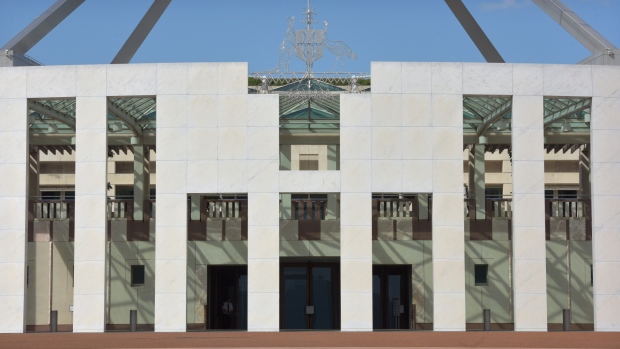 Australia's coat of arms is displayed above the entrance to Parliament House in Canberra, Australia, on Monday, Feb. 4, 2019. Australia's scandal-plagued banks are set for their biggest upheaval in decades as a wide-ranging inquiry into misconduct recommends how the nation's financial industry should atone for wrongdoings. 