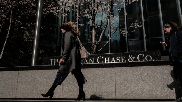 Pedestrians pass in front of a JPMorgan Chase & Co. office building in New York, U.S., on Wednesday, April 11, 2018. JPMorgan Chase & Co. is scheduled to release earnings figures on April 13. 