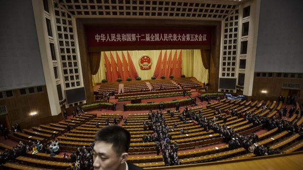 Attendees make their way to the exits after attending an assembly at the fifth session of the 12th National People's Congress (NPC) at the Great Hall of the People in Beijing, China, on Wednesday, March 8, 2017. In his work report to this year’s National People’s Congress, Chinese Premier Li Keqiang said the country has prioritized cutting overcapacity in the steel and coal sectors. 
