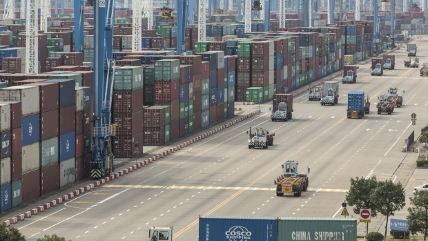 Containers sit stacked next to gantry cranes as trucks operate at the Port of Ningbo-Zhoushan in Ningbo, China, on Wednesday, Oct. 31, 2018. President Donald Trump wants to reach an agreement on trade with Chinese President Xi Jinping at the Group of 20 nations summit in Argentina later this month and has asked key U.S. officials to begin drafting potential terms, according to four people familiar with the matter. 