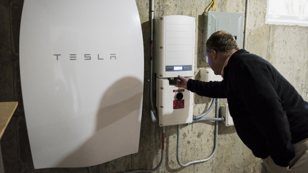 A customer inspects a Tesla Motors Inc. Powerwall unit inside a home in Monkton, Vermont, U.S. 