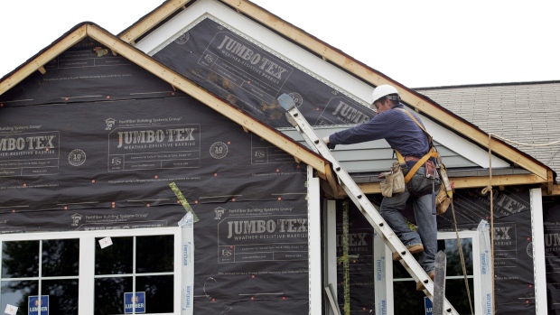 A worker installs vinyl siding on a Centex home under construction at the Pointe in Clayton, North Carolina, U.S. 