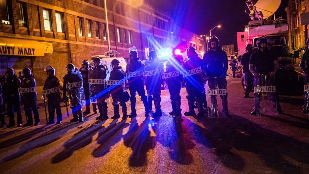 BALTIMORE, MD - MAY 01: Riot police enforce a 10PM curfew and clear the streets of protesters and media on the same day that Maryland state attorney Marilyn J Mosby announced that charges would be filed against Baltimore police officers in the death of Freddie Gray on May 1, 2015 in Baltimore, Maryland. Gray died in police custody after being arrested on April 12, 2015. (Photo by Andrew Burton/Getty Images)