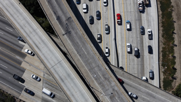Vehicles move along the Interstate 405 freeway during rush hour in this aerial photograph taken over the Westwood neighborhood of Los Angeles, California, U.S.