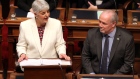 Premier John Horgan looks on as Finance Minister Carole James delivers the budget speech