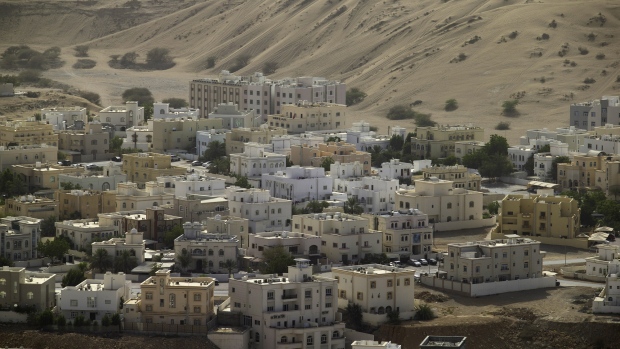 Residential buildings stand beside desert sands in the Bawshar district of Muscat, Oman, on Saturday, May 5, 2018. Being the Switzerland of the Gulf served the country well over the decades, helping the sultanate survive, thrive and make it a key conduit for trade and diplomacy in the turbulent Middle East. 