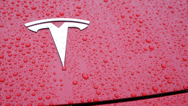 Rain drops surround a Tesla Inc. logo on a Model 3 vehicle ahead of an event at the site of the company's manufacturing facility in Shanghai, China. 