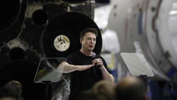 Elon Musk, chief executive officer for Space Exploration Technologies Corp. (SpaceX), gestures as he speaks during an event at the SpaceX headquarters in Hawthorne, California, U.S., on Monday, Sept. 17, 2018.