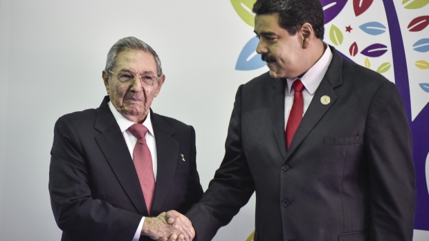 Nicolas Maduro, president of Venezuela, right, and Raul Castro, president of Cuba, shake hands in 2016. Photographer: Carlos Becerra/Bloomberg