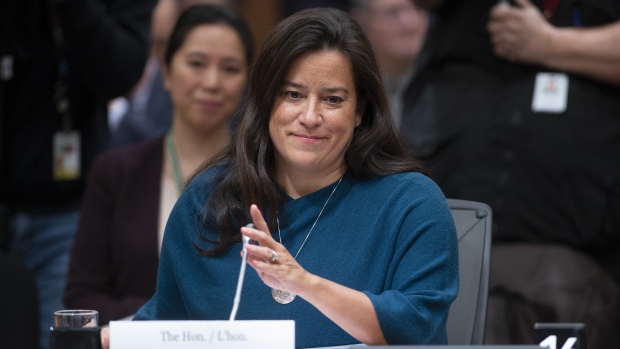 Jody Wilson Raybould adjusts the microphone as she waits to appear infront of the Justice committee 