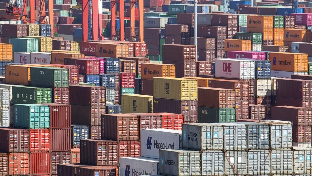 Containers sit stacked at the Yangshan Deep Water Port in Shanghai, China, on Tuesday, July 10, 2018. China told companies to boost imports of goods from soybeans to seafood and automobiles from countries other than the U.S. after trade tensions between the world's two biggest economies escalated into a tariff war last week. 