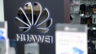 A Huawei Technologies Co. logo sits on display in a store. 