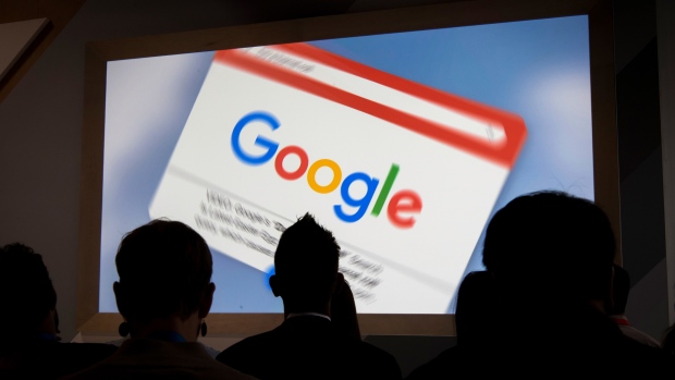 Attendees watch a presentation during a Google Inc. 20th anniversary event in San Francisco, California, U.S., on Monday, Sept. 24, 2018. The search giant announced a raft of new features at an event celebrating its 20th anniversary. A Facebook-like newsfeed populated with videos and articles the company thinks an individual user would find interesting will now show up on the Google home page just below the search bar on all mobile web browsers. 