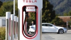 A Tesla Inc. Model S electric vehicle charges at a Supercharger station in Rubigen, Switzerland. 