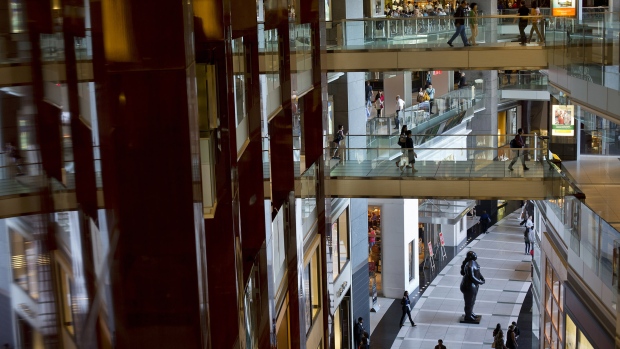 People walk through The Shops at Columbus Circle mall in New York, U.S. 
