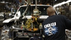 A worker wearing a United Auto Workers (UAW) shirt assembles a Ford Motor Co. Super Duty series pickup truck at the company's truck manufacturing plant in Louisville, Kentucky, U.S. 