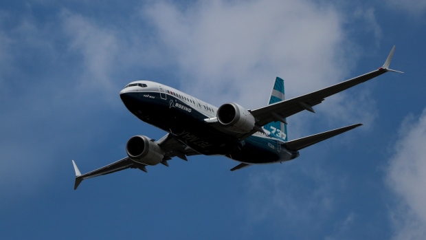 A Boeing Co. 737 Max 7 jetliner flies during the flying display on the opening day of the Farnborough International Airshow (FIA) 2018 in Farnborough, U.K., on Monday, July 16, 2018. The air show, a biannual showcase for the aviation industry, runs until July 22. 