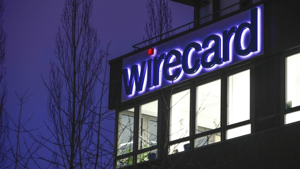 An logo sits above illuminated office windows at the Wirecard AG headquarters at dawn in the Aschheim district of Munich, Germany, on Tuesday, Feb. 12, 2019. Wirecard broke federal securities law by failing to act on an executive’s misconduct and misleading investors about it, a complaint filed Feb. 8 in the Central District of California alleges. 