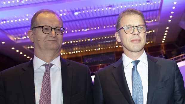 Martin Zielke, chief executive officer of Commerzbank AG, left, and Christian Sewing, chief executive officer of Deutsche Bank AG, right, at the European Banking Congress in the Frankfurt Opera House in Frankfurt, Germany, on Friday, Nov. 16, 2018. Draghi expects the euro area to continue growing in coming years even amid risks from protectionism that need to be monitored very carefully. Photographer: Alex Kraus/Bloomberg