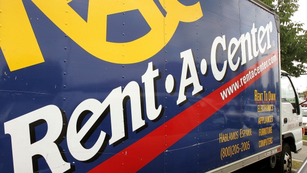 Rent-a-Center signage is seen on a truck parked outside its store. 