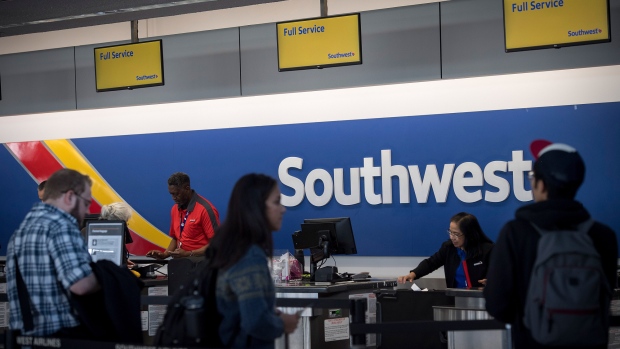 Travelers wait in line at the Southwest Airlines Co. check-in counter at Oakland International Airport (OAK) in Oakland, California, U.S., on Friday, Jan. 19, 2018. Southwest Airlines Co. is scheduled to release earnings on January 25. 