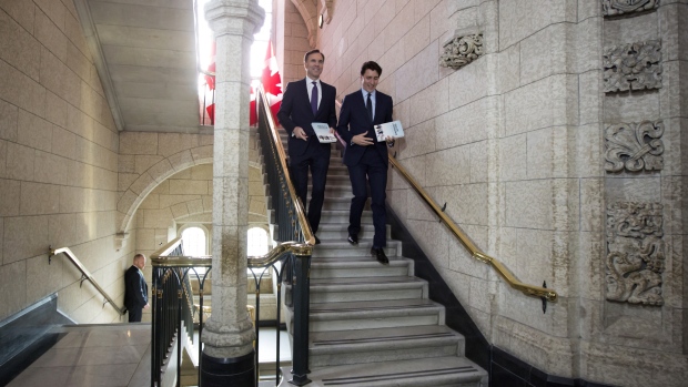 Justin Trudeau, right, and his finance chief Bill Morneau arrive at the House of Commons in Ottawa to deliver their 2018 budget. Photographer: David Kawai/Bloomberg