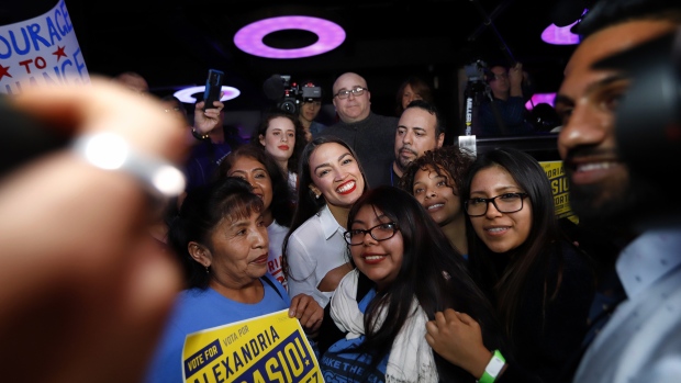 Alexandria Ocasio-Cortez stands with supporters during her during her victory celebration in Queens on Nov. 6, 2018. Photographer: Rick Loomis/Getty Images