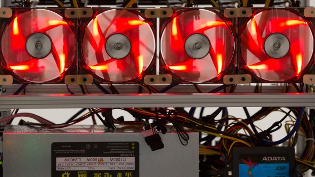 Red light illuminates cooling fans used to cool cryptocurrency mining rigs at the SberBit mining 'hotel' in Moscow, Russia, on Saturday, Dec. 9, 2017. Futureson the worlds most popular cryptocurrency surged as much as 26 percent in their debut session on Cboe Global Markets Inc.'s exchange, triggering two temporary trading halts designed to calm the market. 