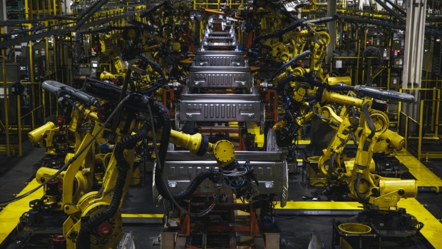 Robotic arms operate on the bed frame of a truck at the Ford Motor Co. Dearborn Truck Plant in Dearborn, Michigan. 