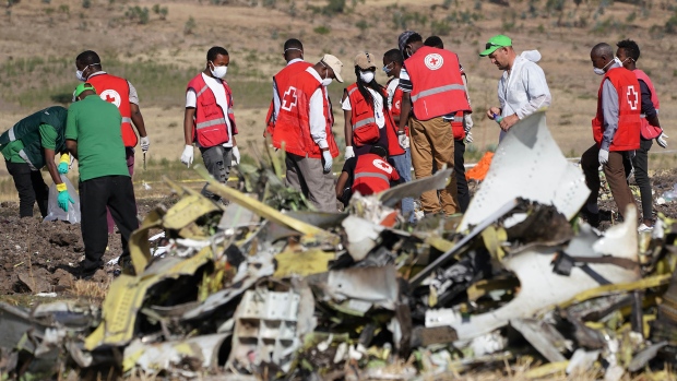 Forensics investigators and recovery teams collect personal effects and other materials from the crash site of Ethiopian Airlines Flight ET 302 on March 12, 2019 in Bishoftu, Ethiopia.