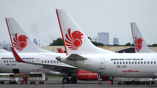A Lion Air Boeing Co. 737 Max 8 aircraft, right, stands on the tarmac at Soekarno-Hatta International Airport in Cenkareng, Indonesia, on Tuesday, March 12, 2019. Indonesia’s Lion Air, one of the biggest customers of Boeing’s 737 Max plane, is suspending delivery of four of the jets it had on order for this year after the second fatal accident involving the model in five months. 