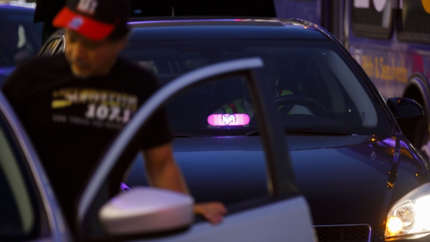 A Lyft Inc. decal is displayed on a car window in Los Angeles, California, U.S., on Monday, Nov. 13, 2017. 