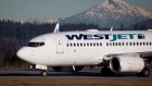 A pilot taxis a Westjet Boeing 737-700 plane to a gate in Richmond