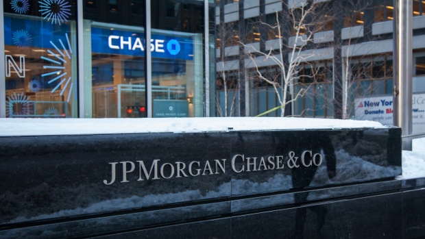 Snow sits on top of signage displayed outside a JPMorgan Chase & Co. bank branch in New York
