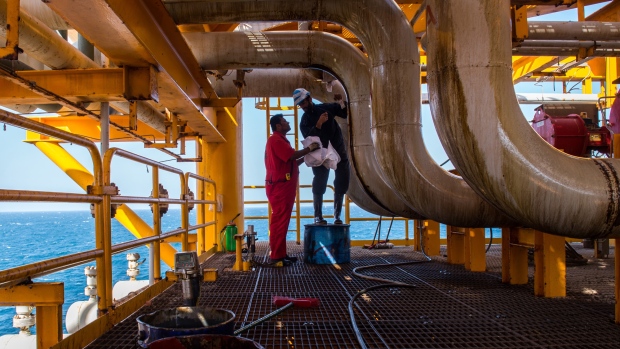 Workers clean oil leaks from pipes aboard an offshore oil platform in the Persian Gulf's Salman Oil Field, operated by the National Iranian Offshore Oil Co., near Lavan island, Iran, on Thursday, Jan. 5. 2017. Nov. 5 is the day when sweeping U.S. sanctions on Iran’s energy and banking sectors go back into effect after Trump’s decision in May to walk away from the six-nation deal with Iran that suspended them. 