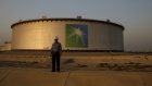 An employee visits the site of crude oil storage tanks at the Juaymah tank farm at Saudi Aramco's Ras Tanura oil refinery and oil terminal in Ras Tanura, Saudi Arabia. 