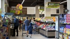 Shoppers walk through the fresh produce department at an Aldi food market in Chicago. Photographer: Daniel Acker/Bloomberg
