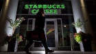A pedestrian walks past a Starbucks Corp. store in Toronto