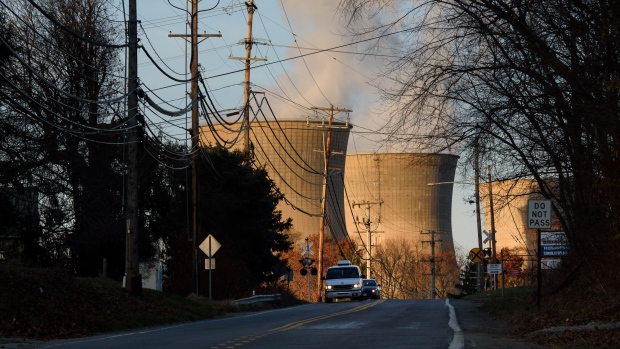 Vehicles drive along a road near the FirstEnergy Corp. Bruce Mansfield coal-fired power plant in Shippingport, Pennsylvania, U.S., on Sunday, Dec. 3, 2017. Across America, few places are as dominated by big, centralized power plants as Shippingport. It was here, in the 1950s, that the federal government teamed up with private industry to build the country's first nuclear power plant. 