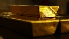Bars of gold bullion sit underneath a 12.5 kilogram gold bar at the Valcambi SA precious metal refinery in Balerna, Switzerland, April 24, 2018