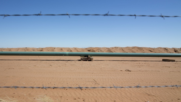 A section of an oil pipeline sits on blocking during construction in the Permian Basin near Pyote, Texas, U.S., on Friday, March 2, 2018. 