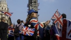 Pro-Brexit campaigners hold Union Flags, also known as Union Jacks, as they rally near the Houses of Parliament in London. 