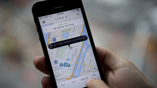Th Uber Technologies Inc. car service application (app) is demonstrated for a photograph on an Apple Inc. iPhone in New York, U.S., on Wednesday, Aug. 6, 2014. 