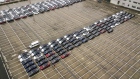 Tesla Inc. Model 3 and Model X electric vehicles sit parked at a port in Shanghai, China.