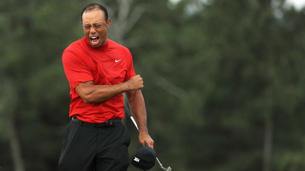 Tiger Woods of the United States celebrates after sinking his putt on the 18th green to win during the final round of the Masters at Augusta National Golf Club on April 14, 2019. Photographer: Mike Ehrmann/Getty Images